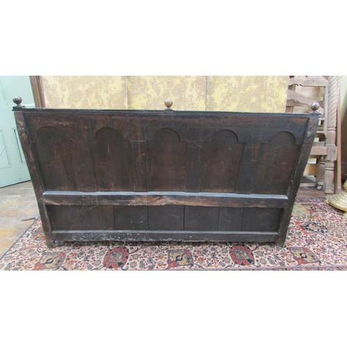 1454 - An antique oak box settle with repeating carved detail, the seat incorporating a rising lid, 185cm l... 