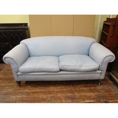 1455 - In the manner of Howard & Sons, an upholstered two seater sofa of generous proportions, with rolled ... 