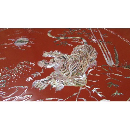 1456 - A red lacquered Chinese  mid  20th century occasional table of rectangular form inlaid in mother of ... 