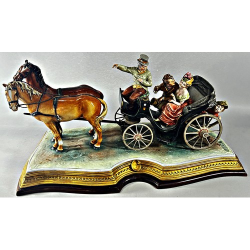 165 - A Capodimonte group of a romantic couple in a horse drawn carriage, B. Merli, raised on a wood plint... 