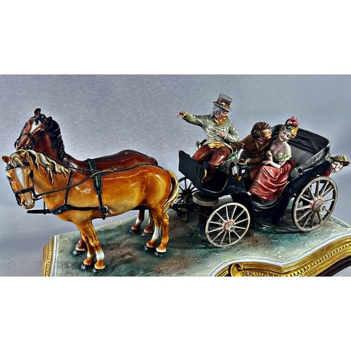 165 - A Capodimonte group of a romantic couple in a horse drawn carriage, B. Merli, raised on a wood plint... 