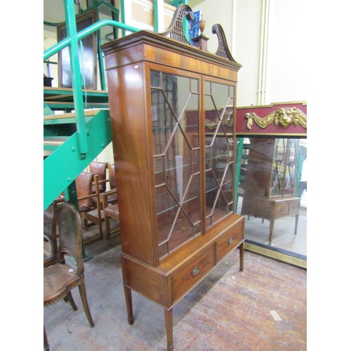 1460 - A Georgian style cabinet on stand, the upper section enclosed by two astragal glazed doors three adj... 