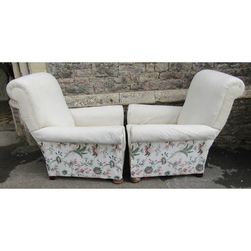 1465 - A pair of traditional easy chairs with scrolled arms and backs, simple upholstered finish, raised on... 