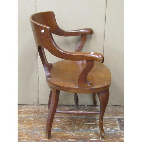 1466 - A late 19th century office chair in oak with dished seat and carved back