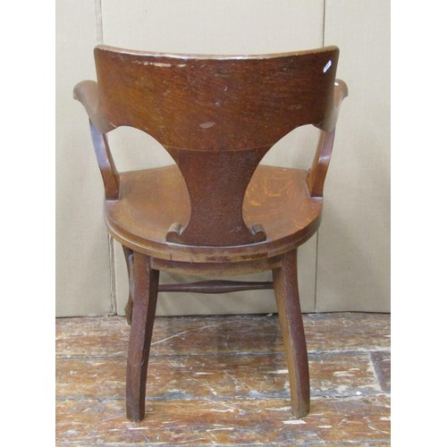 1466 - A late 19th century office chair in oak with dished seat and carved back