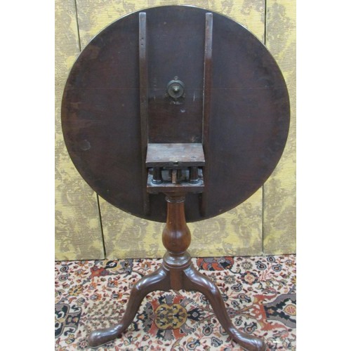 1467 - A Georgian mahogany tripod table the circular one piece top 74cm diameter, raised on a turned vase s... 