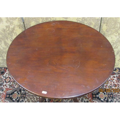 1467 - A Georgian mahogany tripod table the circular one piece top 74cm diameter, raised on a turned vase s... 