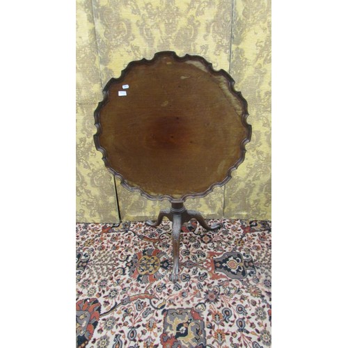 1470 - A 19th century mahogany snap top table, the shaped top with a raised border, on turned pillar and tr... 