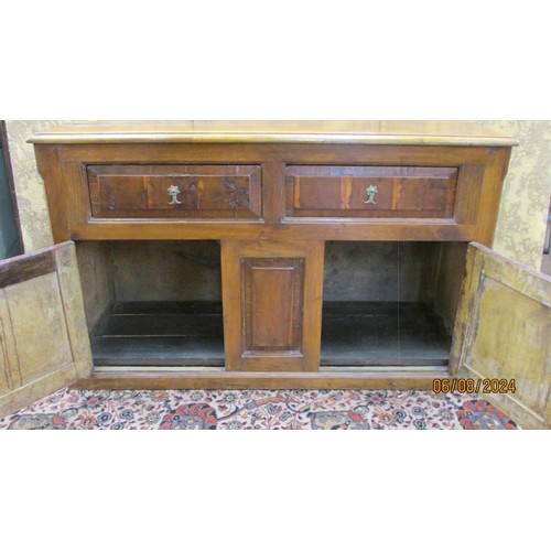 1481 - An antique sideboard in mixed woods to include yew wood enclosed by two panelled doors and two friez... 