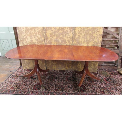 1491 - A mahogany twin pillar table in the Georgian style with single additional leaf to seat eight, 190cm ... 