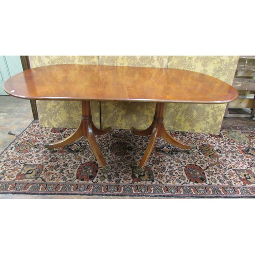 1491 - A mahogany twin pillar table in the Georgian style with single additional leaf to seat eight, 190cm ... 