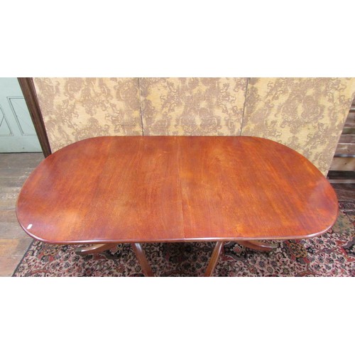 1491 - A mahogany twin pillar table in the Georgian style with single additional leaf to seat eight, 190cm ... 