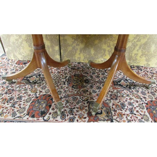 1491 - A mahogany twin pillar table in the Georgian style with single additional leaf to seat eight, 190cm ... 