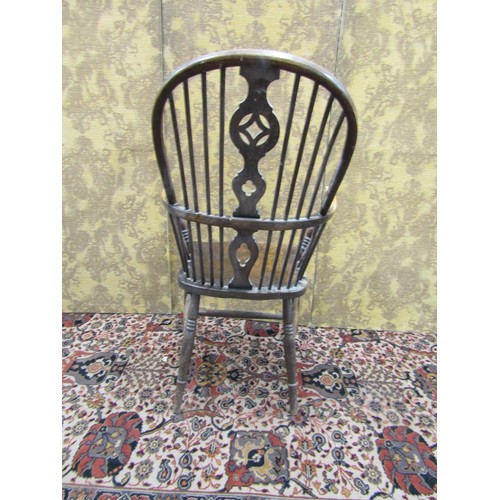 1494 - A Windsor elbow chair with elm seat, shaped and pierced splat on turned supports