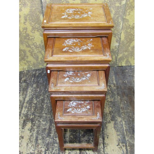 1496 - A graduated set of four Chinese export teak occasional tables, each topped with mother-of-pearl inla... 