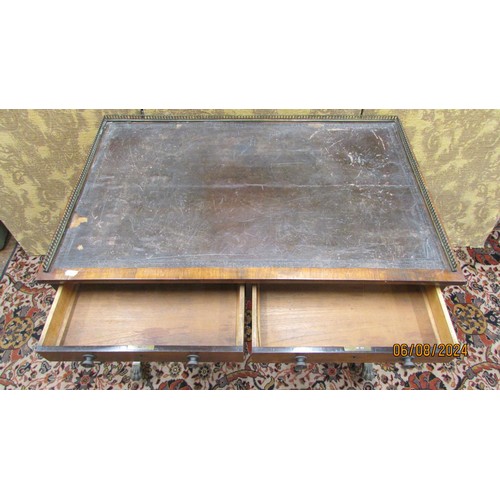 1500 - A small Regency rosewood ladies writing table enclosing two frieze drawers over a stretcher base, sw... 