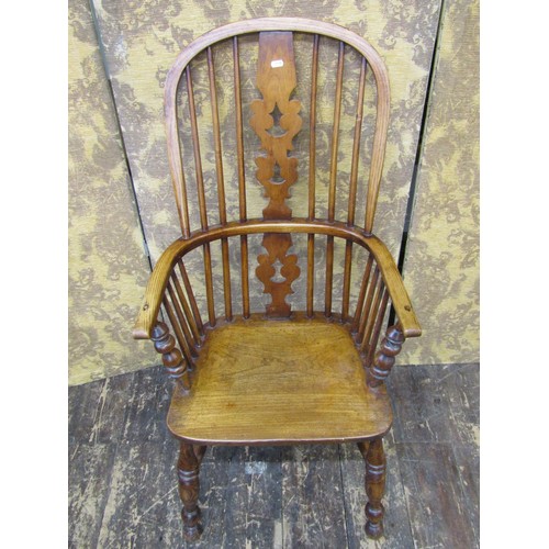 1501 - A 19th century Windsor elbow chair in elm and ash woods, with shaped and pierced splat on turned sup... 