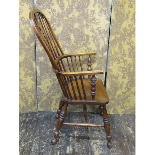 1501 - A 19th century Windsor elbow chair in elm and ash woods, with shaped and pierced splat on turned sup... 