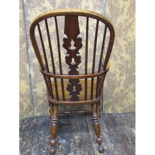 1501 - A 19th century Windsor elbow chair in elm and ash woods, with shaped and pierced splat on turned sup... 