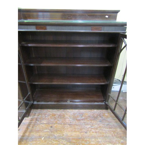 1502 - A large three part mahogany breakfront bookcase, the central writing bureau with fall flap, pigeon h... 