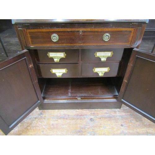 1502 - A large three part mahogany breakfront bookcase, the central writing bureau with fall flap, pigeon h... 