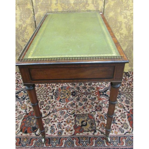 1503 - A small Regency mahogany writing table with two frieze drawers on turned and ringed supports, with i... 