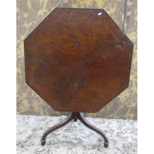 1507 - A Regency mahogany snap top supper table, the figured octagonal top raised on a spiral twist column ... 