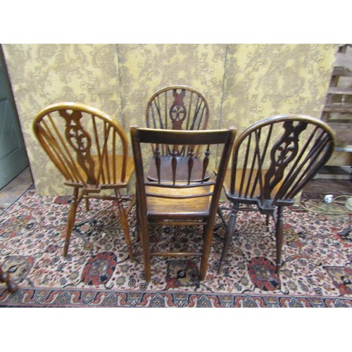 1508 - Three similar Georgian Windsor kitchen chairs principally in elm and ash woods, the shaped fruitwood... 