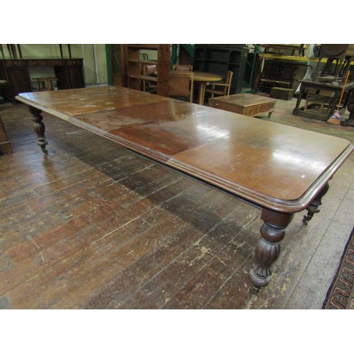 1511 - An early Victorian mahogany extending dining table with three additional leaves, raised on fluted su... 