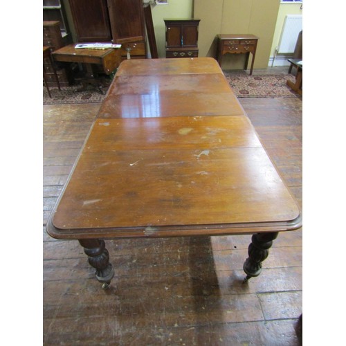 1511 - An early Victorian mahogany extending dining table with three additional leaves, raised on fluted su... 