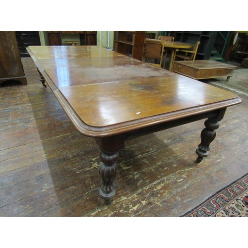 1511 - An early Victorian mahogany extending dining table with three additional leaves, raised on fluted su... 