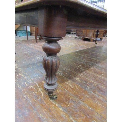 1511 - An early Victorian mahogany extending dining table with three additional leaves, raised on fluted su... 