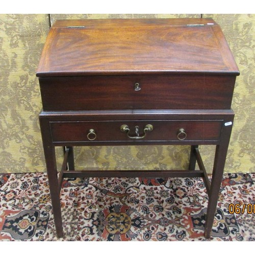 1514 - A Georgian mahogany writing desk on stand, the rising lid revealing a fitted interior of drawers and... 