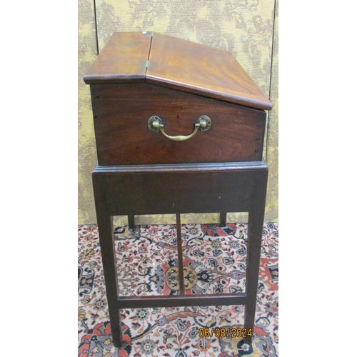 1514 - A Georgian mahogany writing desk on stand, the rising lid revealing a fitted interior of drawers and... 