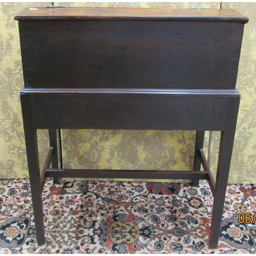 1514 - A Georgian mahogany writing desk on stand, the rising lid revealing a fitted interior of drawers and... 