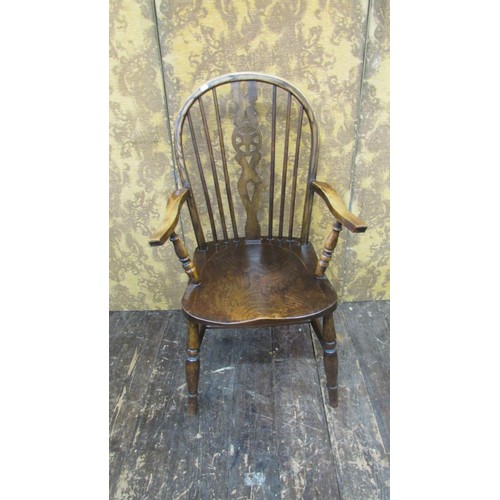 1520 - A Windsor wheelback elbow chair in elm and beechwood