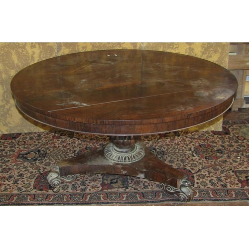 1522 - A regency rosewood supper table raised on a fluted baluster shaped column and tricorn platform base ... 