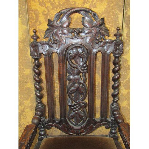 1534 - A Victorian carved oak elbow chair in the Charles II style with profusely carved detail