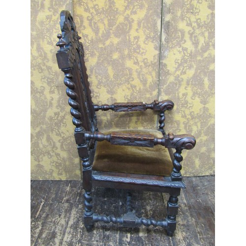 1534 - A Victorian carved oak elbow chair in the Charles II style with profusely carved detail