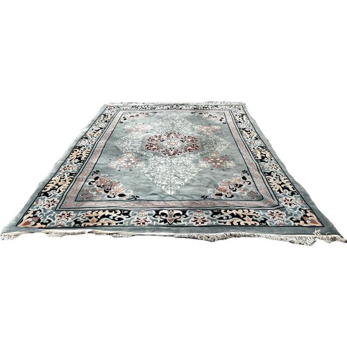 1747 - A Chinese style wool carpet with an allover floral pattern on a pale blue/green ground, 365cm x 275c... 