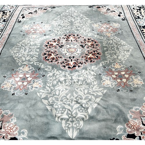 1747 - A Chinese style wool carpet with an allover floral pattern on a pale blue/green ground, 365cm x 275c... 