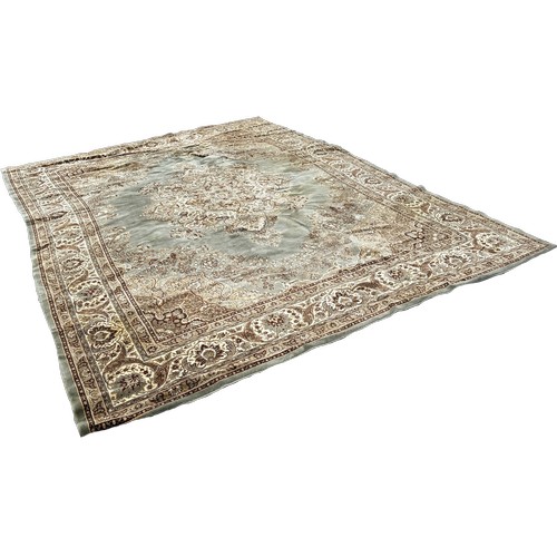 1748 - A Persian style carpet with a central floral medallion on a pale green ground, 350cm x 270cm approxi... 