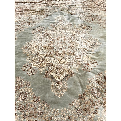 1748 - A Persian style carpet with a central floral medallion on a pale green ground, 350cm x 270cm approxi... 