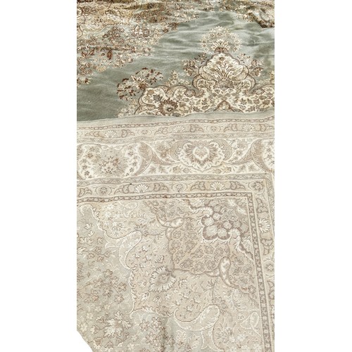 1748 - A Persian style carpet with a central floral medallion on a pale green ground, 350cm x 270cm approxi... 