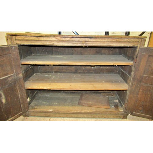 1543 - A large early oak side cupboard, with hinged panelled doors enclosing a shelved interior, 113cm high... 