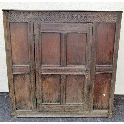 1544 - An old English oak sideboard, with shallow carved frieze above a single hinged panelled door with fl... 