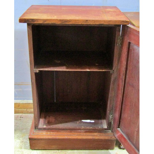 1549 - A small mahogany cupboard with arched panelled door enclosing a shelved interior, 79cm high, 51 x 37... 