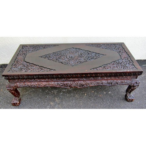 1551 - A carved Eastern stained hardwood coffee / low occasional table, with floral and foliate detail, rai... 