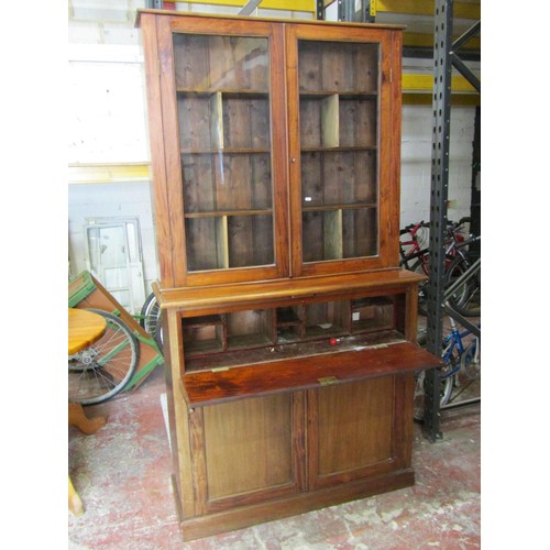 1553A - A freestanding mahogany bookcase with glazed panelled doors enclosing a divisional shelved interior,... 