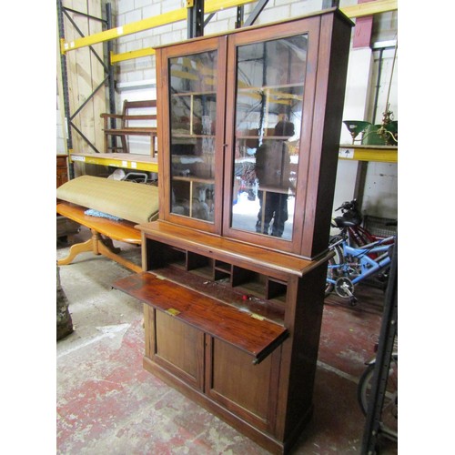 1553A - A freestanding mahogany bookcase with glazed panelled doors enclosing a divisional shelved interior,... 